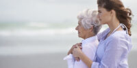 Shot of a beautiful young woman and her senior mother on the beach